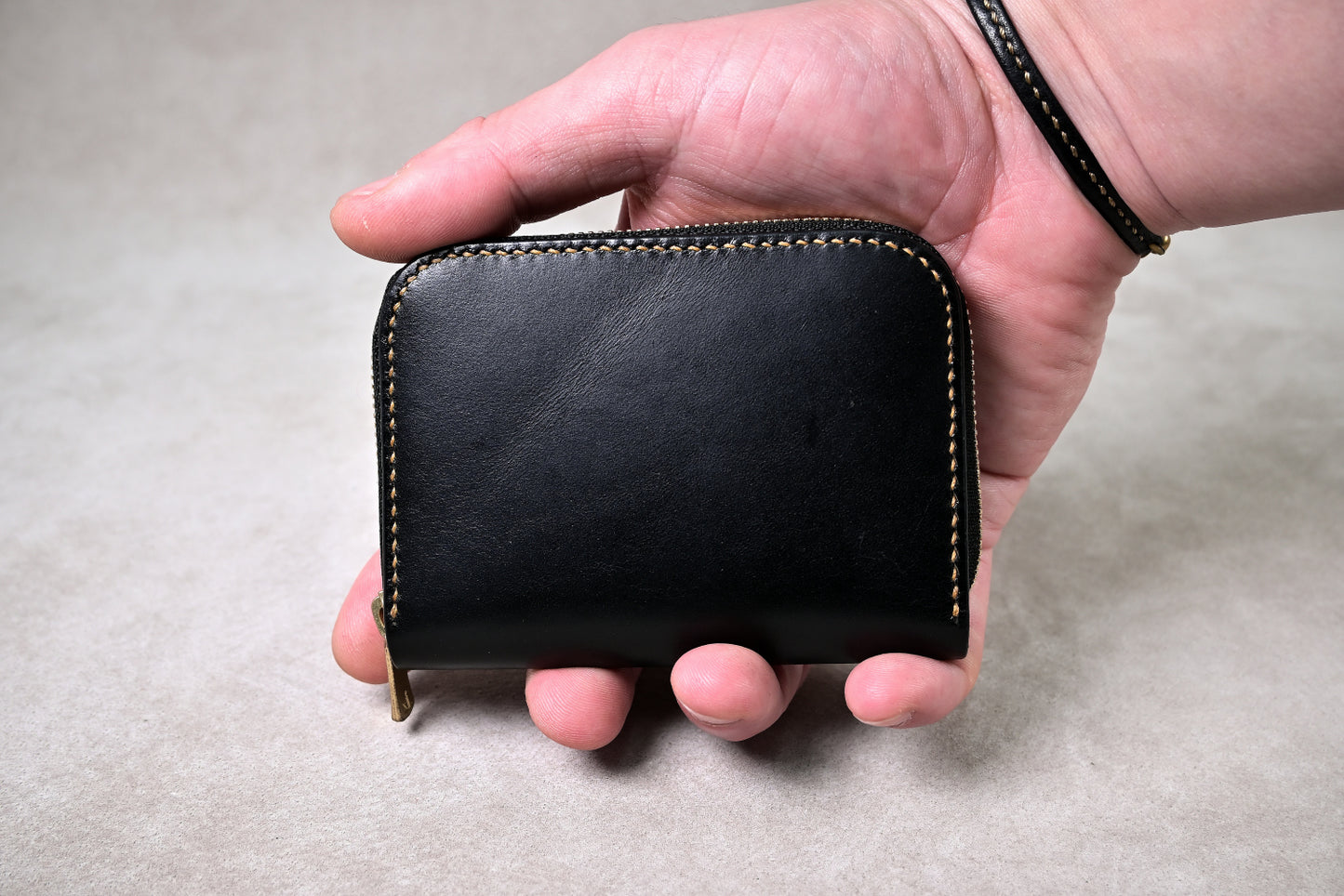 手に持った状態でのサイズ感を撮影(手のひらに収まるコンパクト設計、ブッテーロの艶が映える)